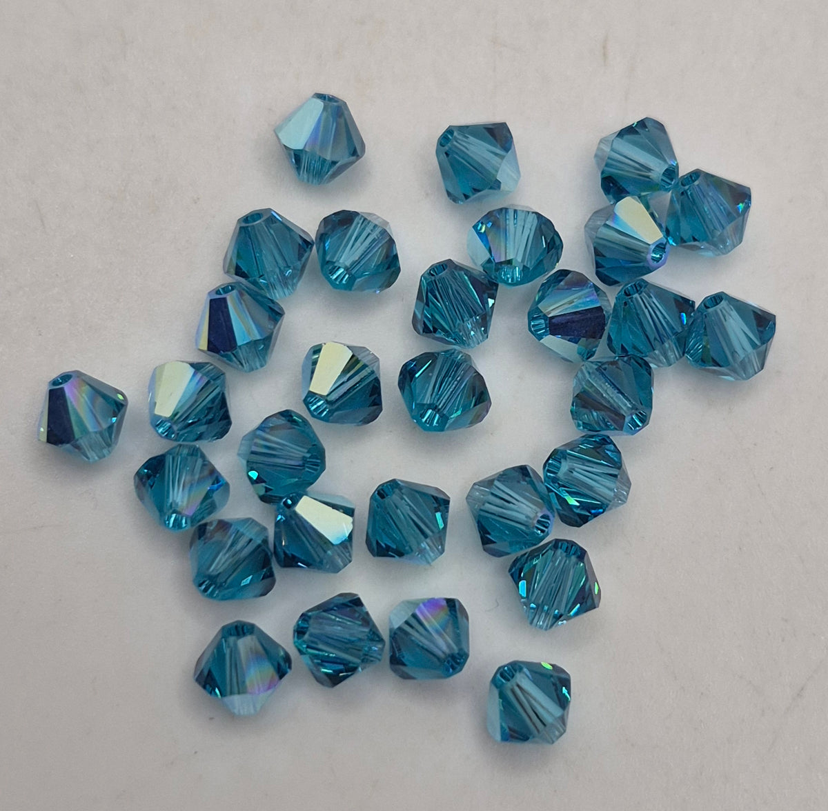 #5328 - Swarovski Crystal Indicolite AB 5mm Bicone Beads; 24pc per pack
